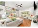 Open-concept living room with hardwood floors, bright windows, and comfortable seating at 114 Misty Meadows Ct, Mooresville, NC 28117