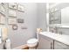 Bright powder room features gray cabinets, a neutral wall color and stylish decor at 114 Misty Meadows Ct, Mooresville, NC 28117