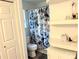 Clean bathroom with decorative blue and white shower curtain at 11824 Larkridge Ct, Charlotte, NC 28226