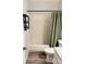 Tiled bath and shower combination paired with modern fixtures and neutral tones provide a functional space at 11824 Larkridge Ct, Charlotte, NC 28226