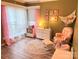 Adorable Bedroom featuring a rocking chair, soft colors, and decorative wall art, creating a comforting atmosphere at 11824 Larkridge Ct, Charlotte, NC 28226