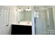 This bathroom offers a double sink vanity, great lighting, and a glass shower, with an adjacent door at 12421 Fiorentina St, Charlotte, NC 28277