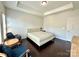 Bedroom with tray ceiling, two armchairs, and a bed with upholstered headboard at 12421 Fiorentina St, Charlotte, NC 28277