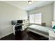 Bedroom with a twin bed, dark wood floors, white desk, and a large window for natural light at 12421 Fiorentina St, Charlotte, NC 28277