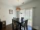 Inviting dining area with dark wood table, tropical print chairs, and a modern woven pendant light fixture at 12421 Fiorentina St, Charlotte, NC 28277