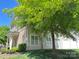 Exterior view of the townhome showing the lawn, patio and natural light at 12421 Fiorentina St, Charlotte, NC 28277