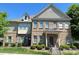 Charming brick townhome with well-maintained landscaping and a welcoming entrance on a sunny day at 12421 Fiorentina St, Charlotte, NC 28277