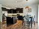 Modern kitchen featuring dark cabinetry, stainless steel appliances, and a stylish dining area at 12421 Fiorentina St, Charlotte, NC 28277