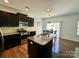 Kitchen with granite counters, stainless steel appliances, an island with sink, and breakfast nook at 12421 Fiorentina St, Charlotte, NC 28277