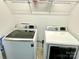 Modern laundry room showcases a Samsung washer and dryer, and wire shelving for efficient storage at 12421 Fiorentina St, Charlotte, NC 28277