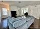Bright and airy living room with a fireplace, wood floors, and a comfortable blue sectional sofa at 12421 Fiorentina St, Charlotte, NC 28277