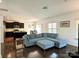 Inviting living room featuring a plush blue sectional sofa, wood floors, and an open floor plan at 12421 Fiorentina St, Charlotte, NC 28277