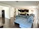 Open concept living room with a plush blue sofa and a view into the modern kitchen and dining area at 12421 Fiorentina St, Charlotte, NC 28277