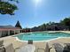 Large community swimming pool with chairs and tables for residents to enjoy on a sunny day at 12421 Fiorentina St, Charlotte, NC 28277