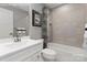 Well-lit bathroom featuring tiled shower and bath, providing a clean and modern space at 1344 Holden Sw Ave, Concord, NC 28025