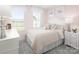 Cozy bedroom with soft pink walls, a comfortable bed, and plenty of natural light at 1358 Holden Sw Ave, Concord, NC 28025