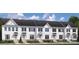 Charming row of new white townhomes with black shutters and manicured landscaping at 1358 Holden Sw Ave, Concord, NC 28025