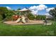 Community playground featuring slides, swings, and climbing equipment with a seating area perfect for families in a well-maintained park at 1358 Holden Sw Ave, Concord, NC 28025