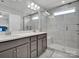 Bright bathroom with double sinks, modern vanity, tiled shower, and glass door at 138 Marron Dr # 25, Indian Trail, NC 28079