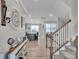 Inviting foyer with wood floors, a staircase, and decor leading to the kitchen at 138 Marron Dr # 25, Indian Trail, NC 28079