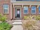 Inviting entryway featuring a gray front door, brick facade, and well-manicured landscaping at 138 Marron Dr # 25, Indian Trail, NC 28079