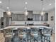 Open kitchen featuring a large island with bar stool seating, white countertops and ample gray cabinetry at 138 Marron Dr # 25, Indian Trail, NC 28079