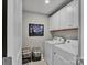 Well-organized laundry room with white cabinets, washer, dryer, and ample storage at 138 Marron Dr # 25, Indian Trail, NC 28079