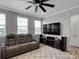 Spacious living room with a large TV, reclining sofa, ceiling fan, and natural light at 138 Marron Dr # 25, Indian Trail, NC 28079