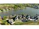 An aerial view of the houses in a lakeside community with manicured lawns and lake access at 140 Sisters Cove Ct, Mooresville, NC 28117