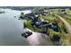 Aerial view of a lakeside community, showcasing waterfront homes and manicured lawns at 140 Sisters Cove Ct, Mooresville, NC 28117