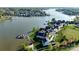 Aerial view of a lakeside community with waterfront homes and private boat docks at 140 Sisters Cove Ct, Mooresville, NC 28117