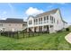 A white home with a fenced yard and a screened-in back porch, perfect for outdoor entertaining at 140 Sisters Cove Ct, Mooresville, NC 28117