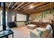 Finished basement with movie screen, TV and comfortable seating at 140 Sisters Cove Ct, Mooresville, NC 28117