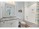 Bright bathroom with white tiled shower and decorative mirror at 140 Sisters Cove Ct, Mooresville, NC 28117