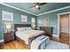Bright bedroom featuring hardwood floors, ceiling fan, and wooden furniture at 140 Sisters Cove Ct, Mooresville, NC 28117