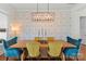 Elegant dining area with hardwood floors, stylish wallpaper, and a modern chandelier at 140 Sisters Cove Ct, Mooresville, NC 28117