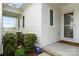 A close-up of a welcoming home entrance features a covered porch and well-maintained landscaping at 140 Sisters Cove Ct, Mooresville, NC 28117
