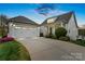 Charming home featuring an attached two-car garage, landscaped yard, and welcoming front porch at 140 Sisters Cove Ct, Mooresville, NC 28117