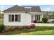 A charming home features a stone foundation, well-maintained landscaping, and a welcoming front porch at 140 Sisters Cove Ct, Mooresville, NC 28117