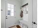 Inviting foyer with coat rack bench, white trim, and natural light, offering a welcoming entrance to the home at 140 Sisters Cove Ct, Mooresville, NC 28117