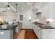 Well-lit kitchen with white cabinetry, granite countertops, stainless steel appliances, and seamless flow into the dining area at 140 Sisters Cove Ct, Mooresville, NC 28117