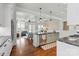 Open concept kitchen with stainless steel appliances, granite countertops and seamless flow into the inviting living area at 140 Sisters Cove Ct, Mooresville, NC 28117