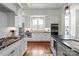 Modern kitchen featuring stainless steel appliances, a gas range, granite countertops, and ample cabinet space for storage at 140 Sisters Cove Ct, Mooresville, NC 28117