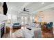 Comfortable living room with a fireplace, hardwood floors, and seamless transition to the dining area at 140 Sisters Cove Ct, Mooresville, NC 28117