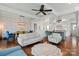 An open-concept living space with hardwood floors, elegant furnishings, and a seamless connection to the kitchen at 140 Sisters Cove Ct, Mooresville, NC 28117