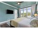 Spacious main bedroom with water view, providing a peaceful sanctuary with natural light and comfortable furnishings at 140 Sisters Cove Ct, Mooresville, NC 28117