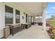 Spacious covered patio with outdoor kitchen and lounge seating at 140 Sisters Cove Ct, Mooresville, NC 28117