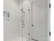 Updated shower with white tile surround and glass door at 140 Sisters Cove Ct, Mooresville, NC 28117
