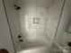 Sleek bathroom featuring modern bathtub and shower with tiled walls and recessed lighting at 1413 Hateras Ave, Charlotte, NC 28216