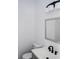 Stylish bathroom features modern vanity with black hardware and lighting at 1413 Hateras Ave, Charlotte, NC 28216